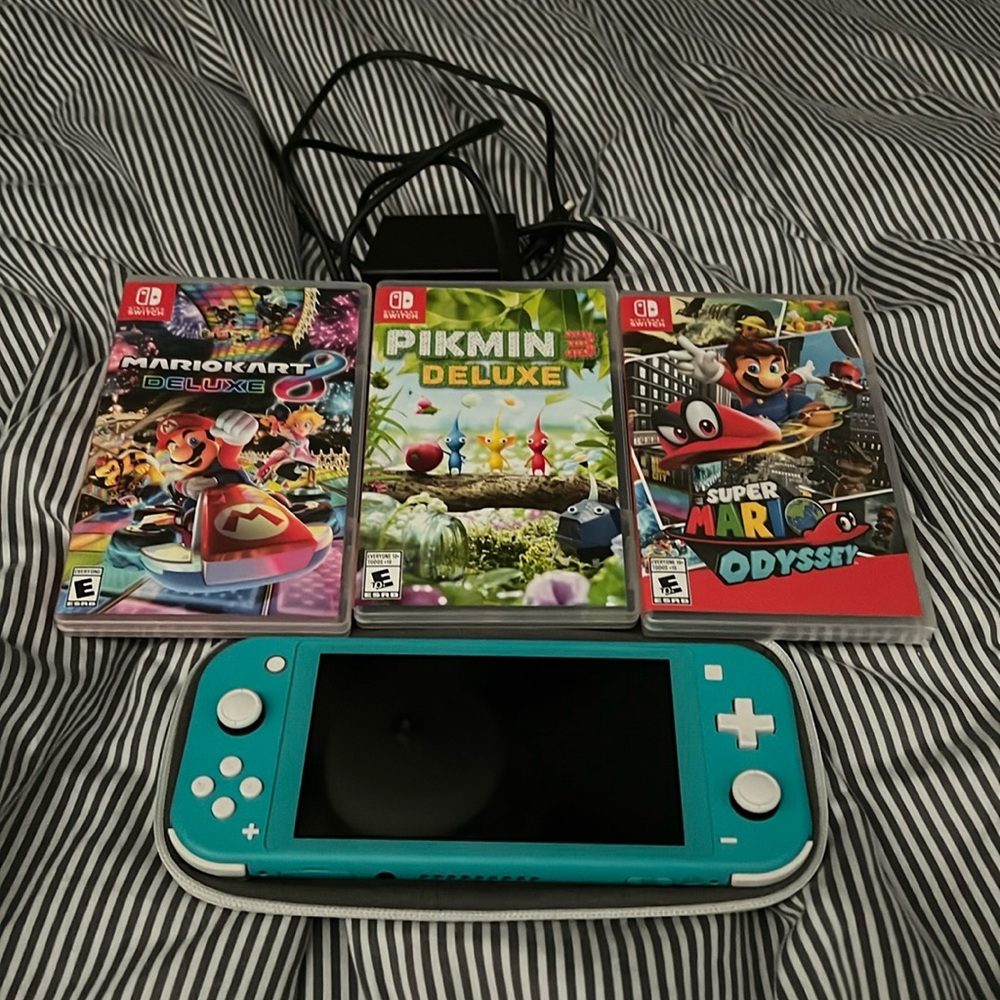 Nintendo Switch (Turquoise) x3 games 1 game is unopened.